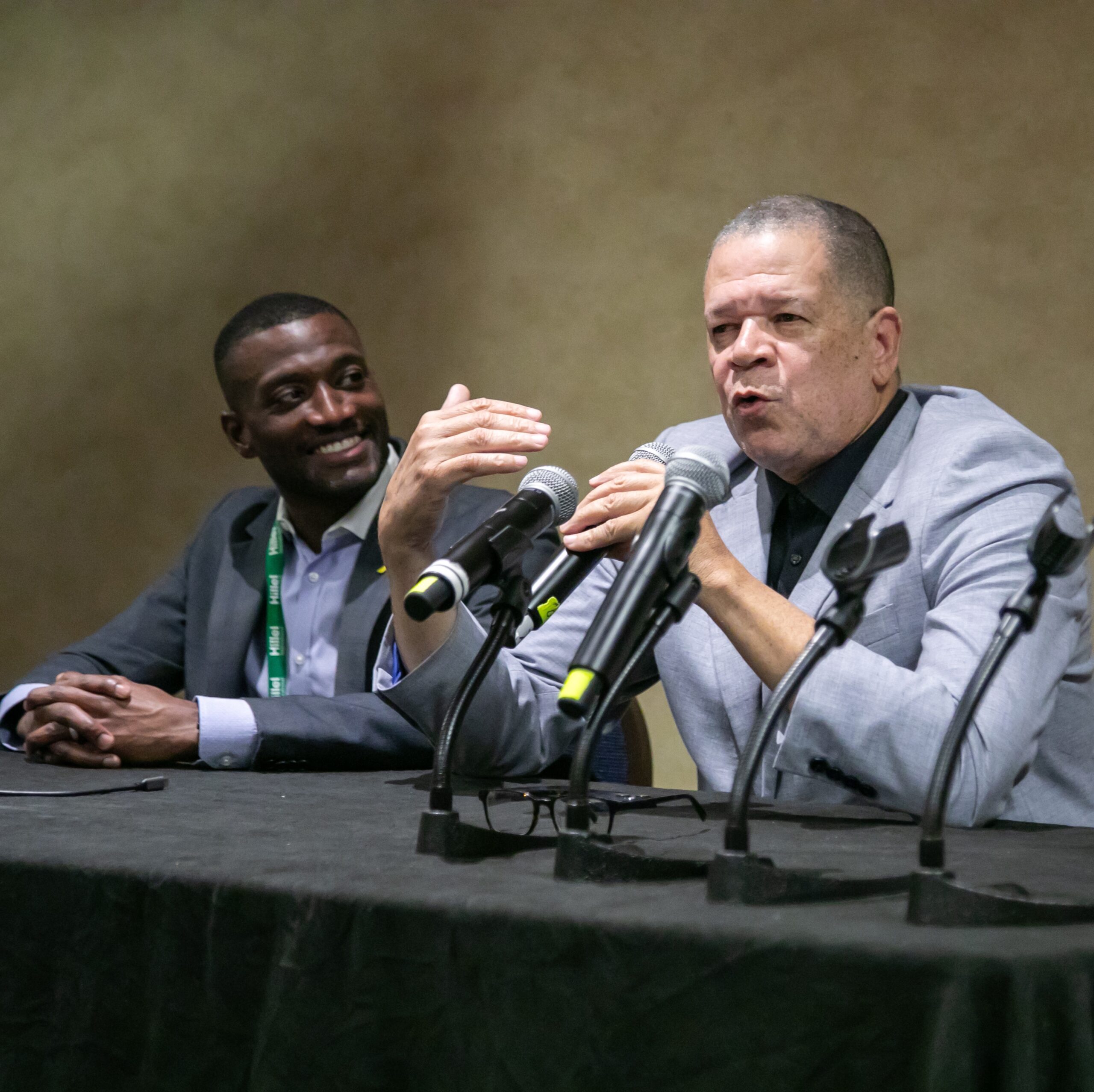 Two men at a conference panel